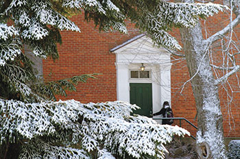 Snow covered tree next to a building. Links to Gifts of Appreciated Securities